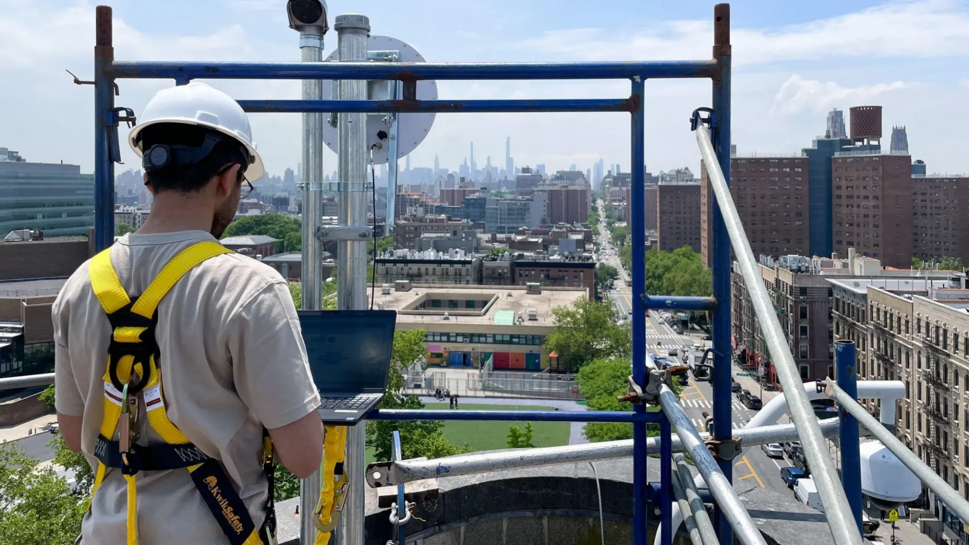 image of researcher standing over Harlem looking at computer testbed