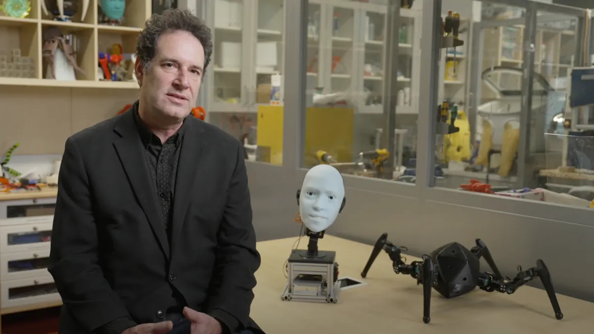Hod Lipson in front of robotics equipment