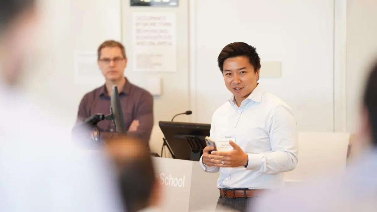 Dan Wang, Columbia Business School's Lambert Family Professor, speaking at podium