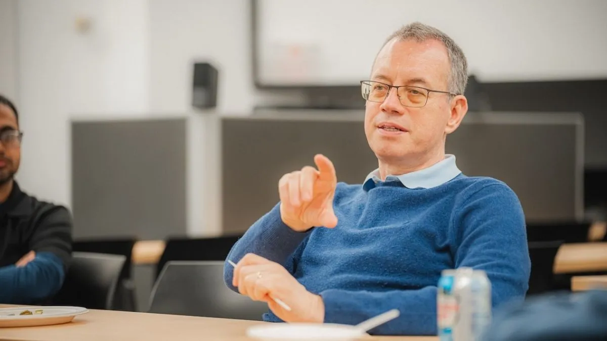 Ion Stoica, seated in a discussion setting, gesturing while speaking. 