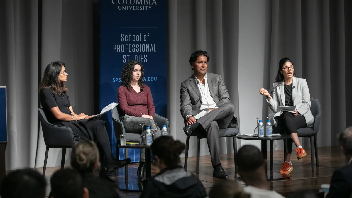 Four panelists discuss AI and sustainability at a Columbia University SPS event, with an audience in front.