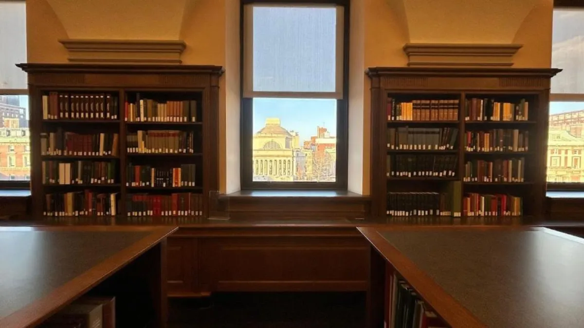 A photograph of bookshelves taken inside Columbia University's Butler Library 
