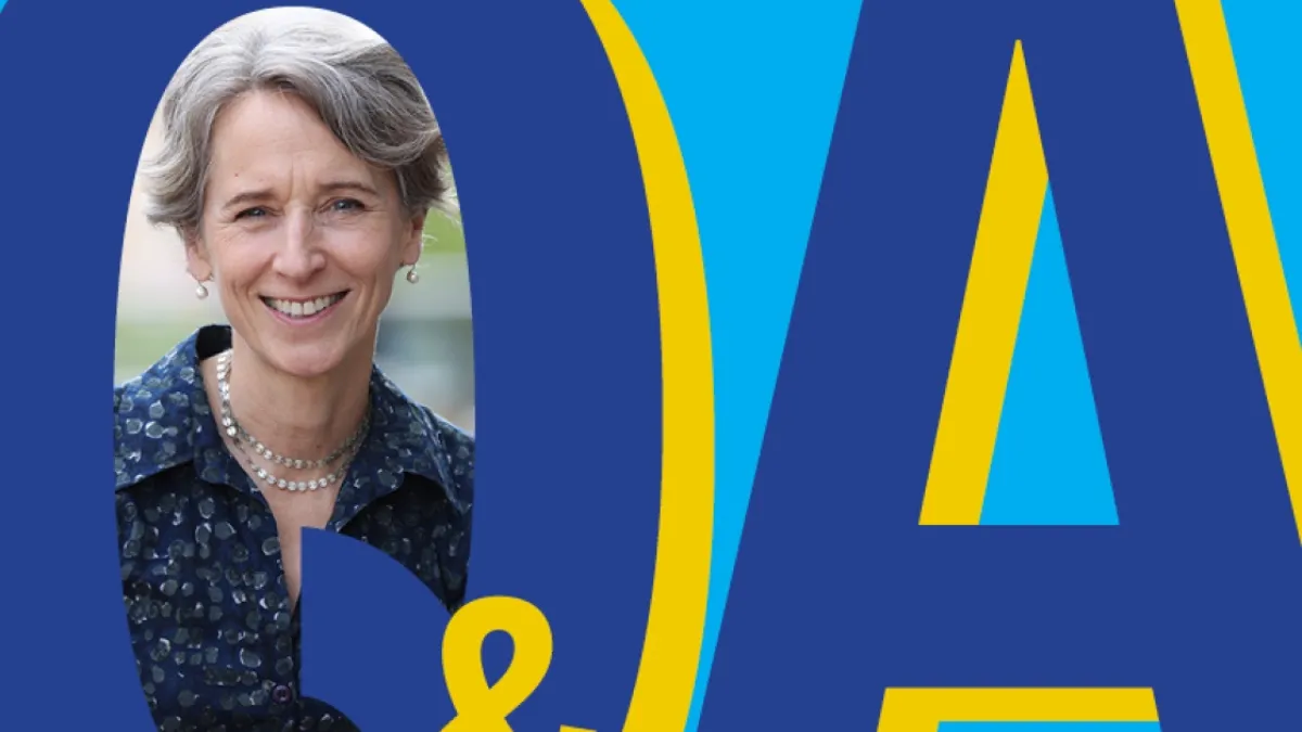The letters 'Q' and 'A' are displayed, with a woman's picture inserted inside the circular space in the letter 'Q'. The '&' symbol is visible in the bottom of the image, on the edge of the letter 'Q'. 