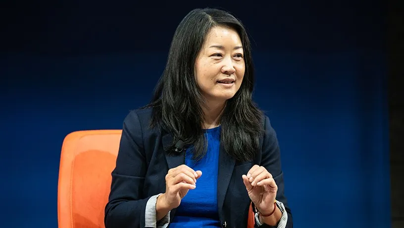 An Asian women speaking from a panelist chair