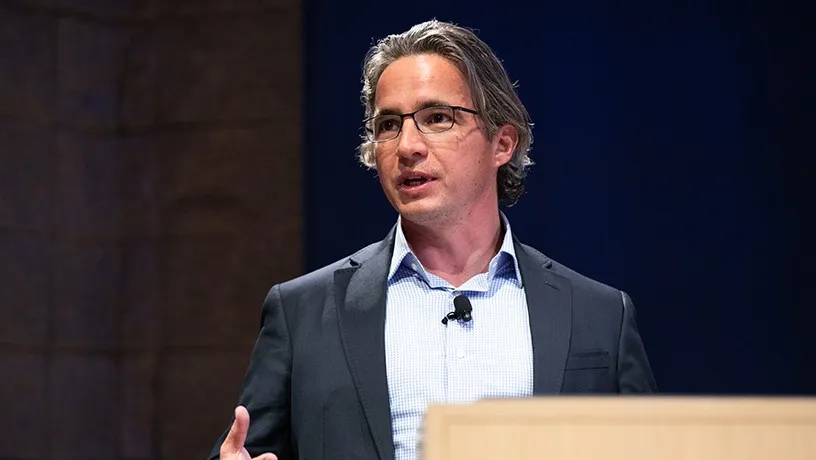 Eric Poirier speaking and gesturing